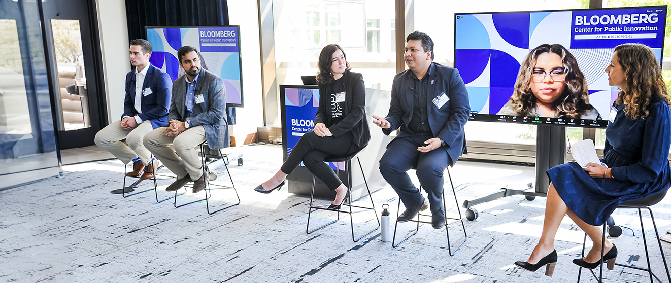 Summer Scholars Showcase 2023-171_R_banner A group of panelists seated on stools