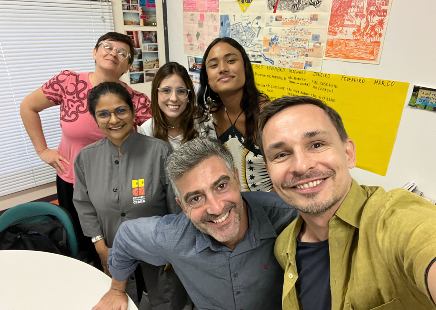 A group of people gathered with Public Innovation Fellow Tommi Laitio and smiling for the camera