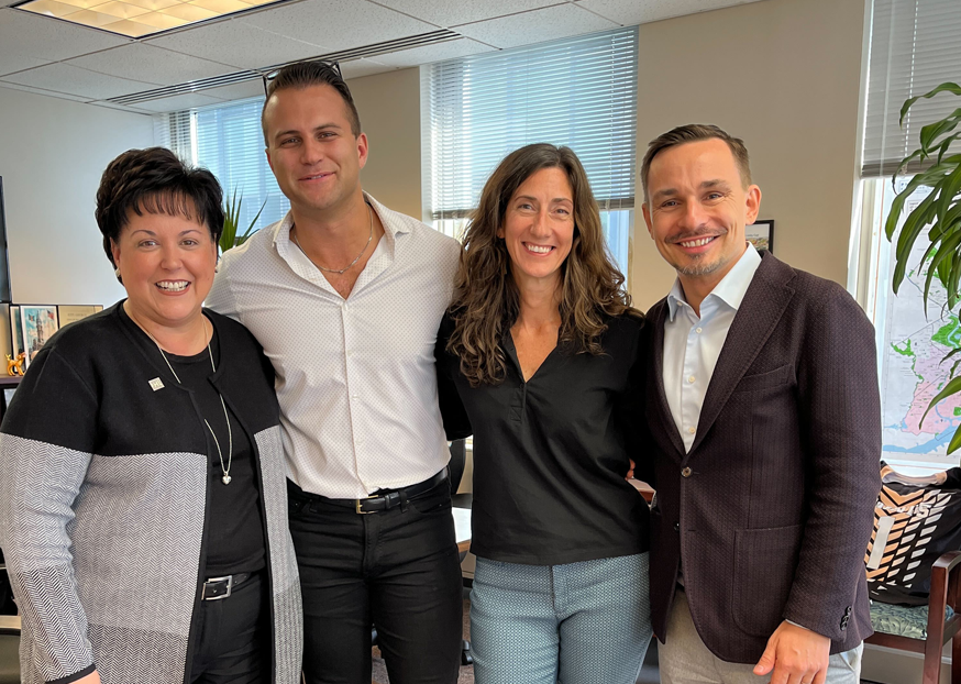 A group of people gathered together smiling for the camera